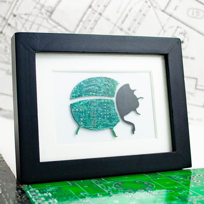 handmade framed art made from recycled circuit boards fashioned into a beetle