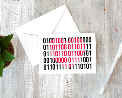 programmer greeting card in the shape of a heart that says I love you in binary