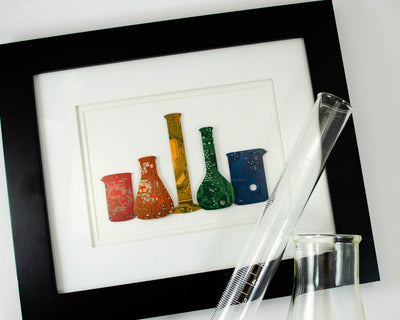 handmade rainbow circuit board framed art piece featuring chemistry glassware