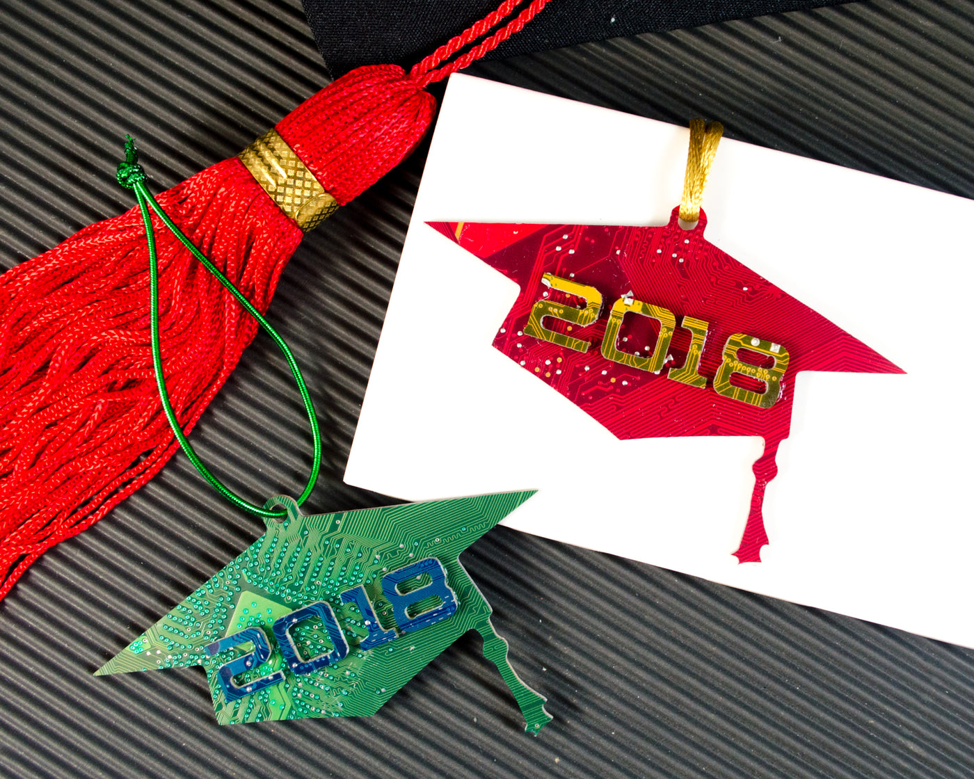 red and green graduation cap ornaments with graduation year