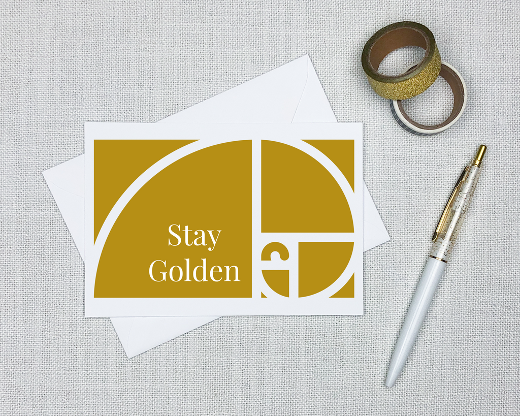 this math greeting card shows a mustard yellow colored depiction of the golden ratio and has text that says stay golden