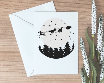 funny holiday card with an image of dinosaurs pulling santas sleigh