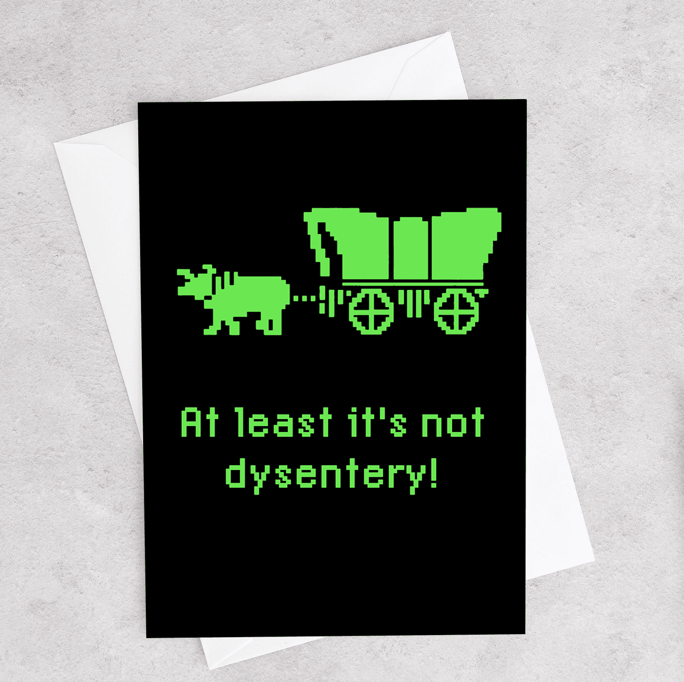 This greeting card has a pixeled ox and wagon like the Oregon Trail computer game and the card says "At Least it's Not Dysentery!"