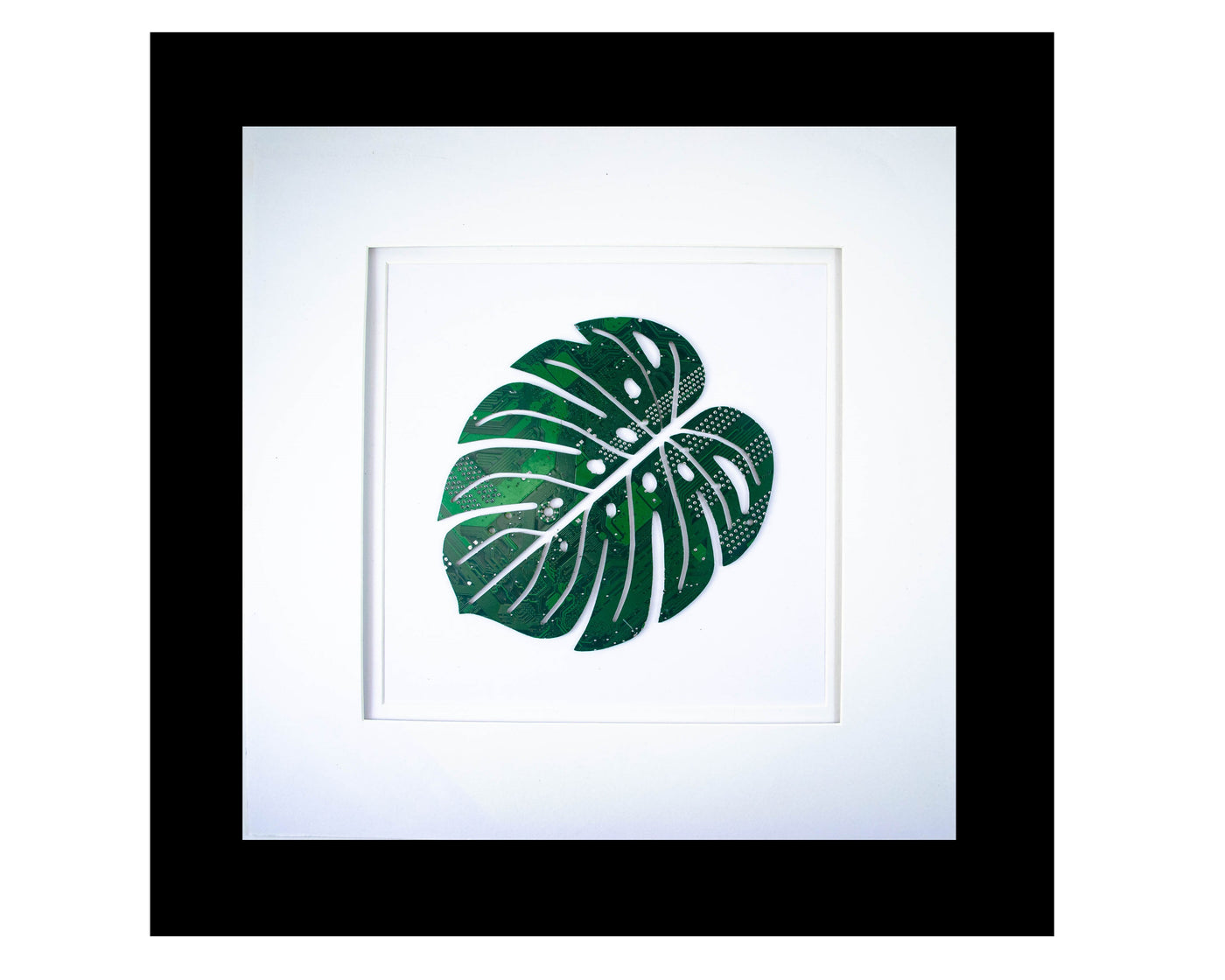 handmade recycled circuit board wall art in the shape of a monstera leaf plant