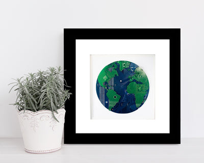 handmade circuit board art made from green and blue motherboards in the shape of the globe. Celebrate earth day with this handmade upcycled art piece