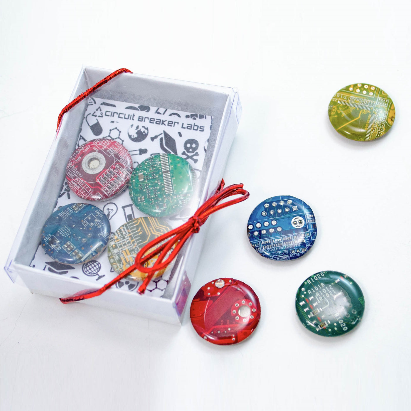 handmade circle magnets in red yellow, green, and blue made from recycled motherboards made in maryland