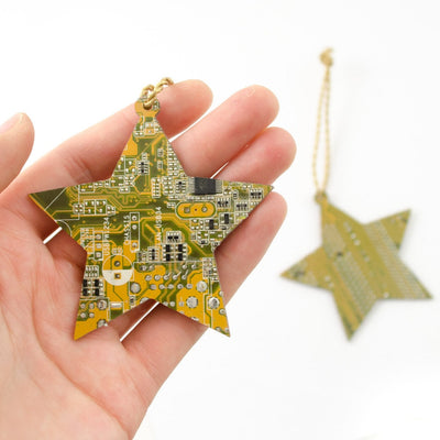 yellow star handmade circuit board ornament held in hand