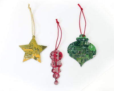 three circuit board ornaments in different festive shapes