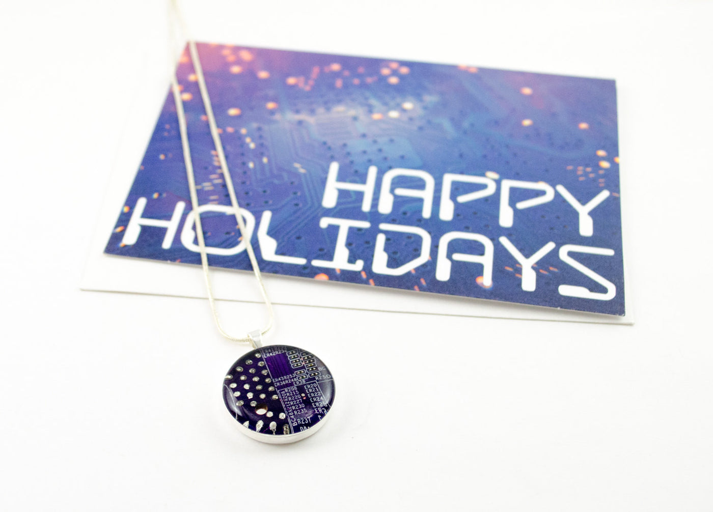 blue happy holidays greeting card with necklace