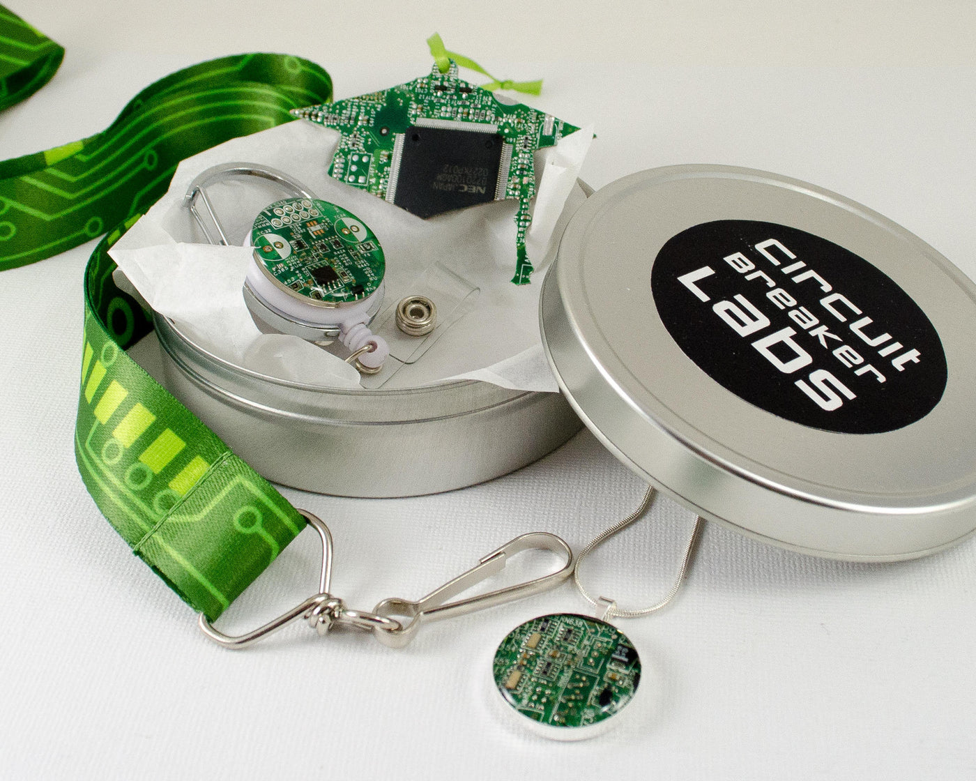 graduation gift set with cap ornament, necklace, lanyard, and badge reel