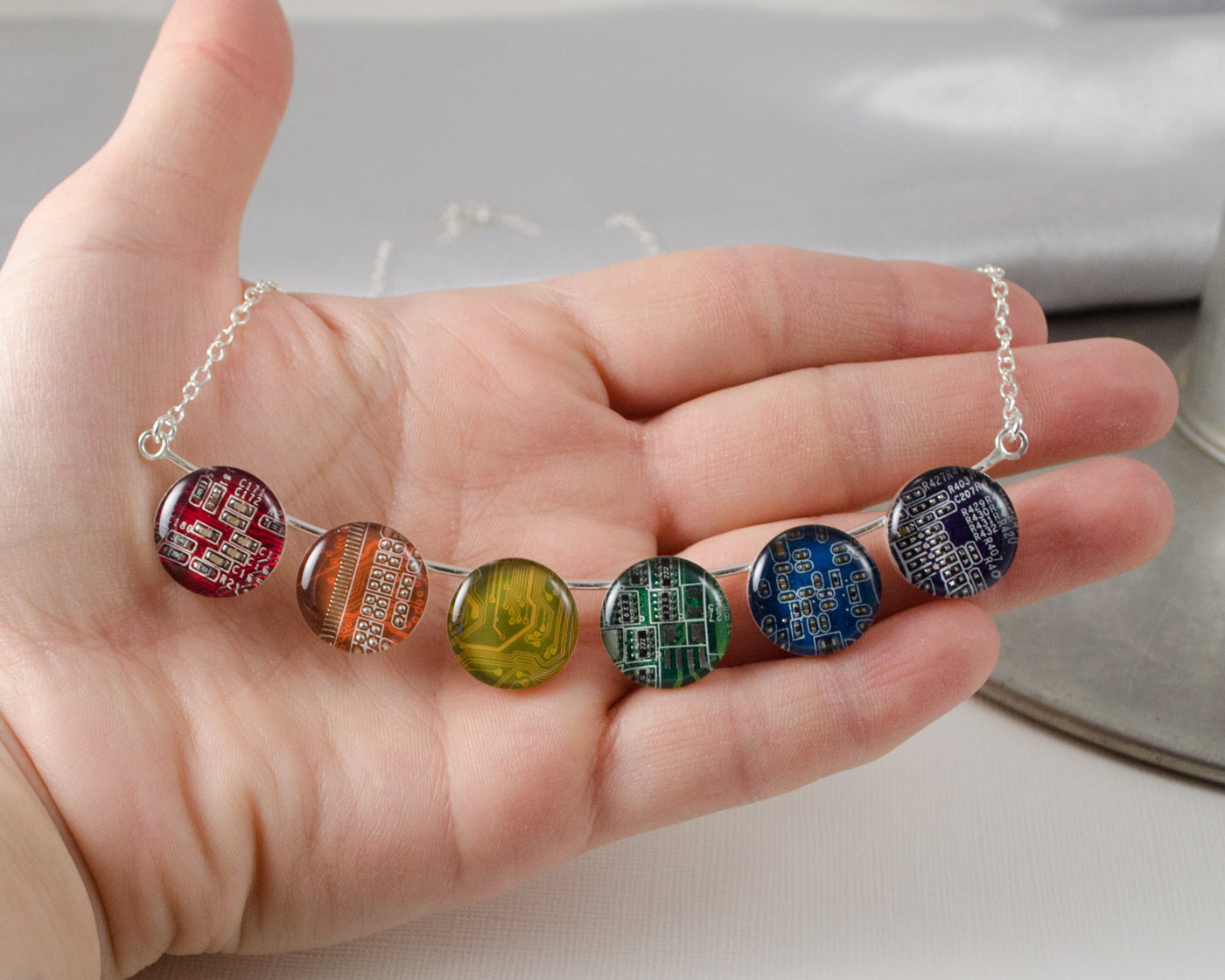 hand holding rainbow necklace