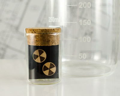 wooden radiation symbol earrings packaged in mini test tube
