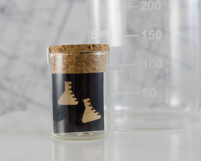 wooden erlenmeyer flask earrings packaged in mini test tube