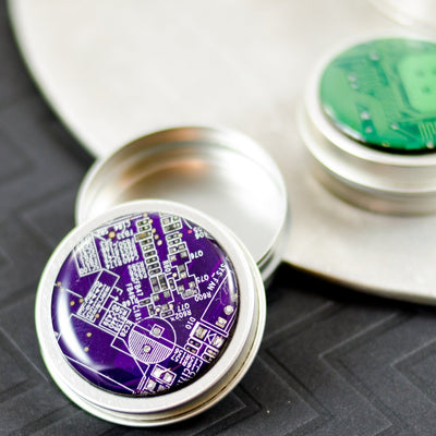 purple and green circuit board metal pill box