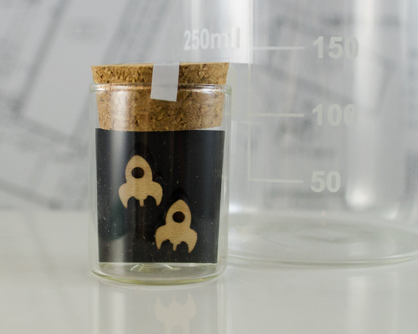 wooden rocket post earrings packaged in mini test tube
