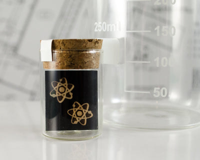 wood atom earrings packaged in mini test tube