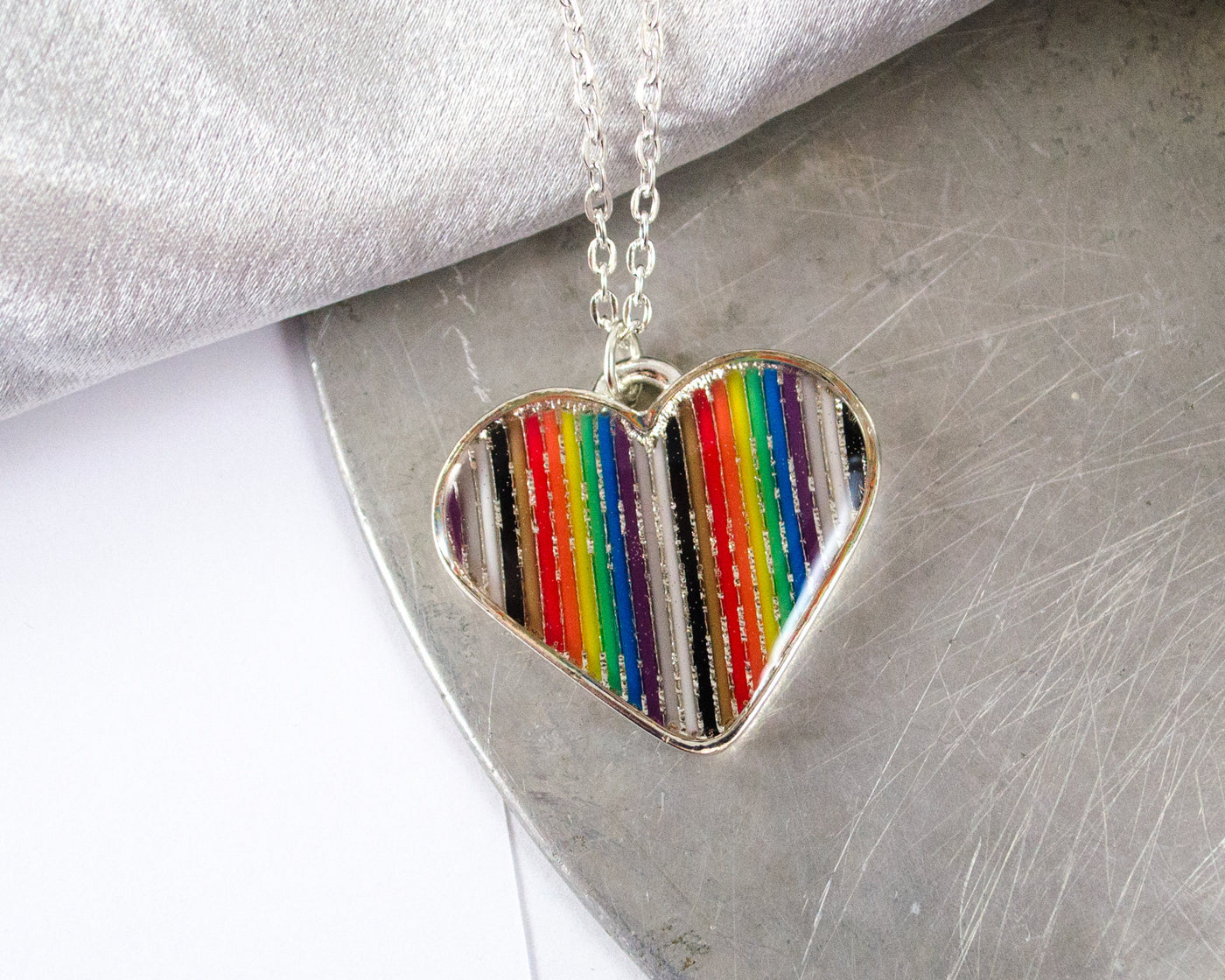 rainbow ribbon cable made into a heart necklace with resin
