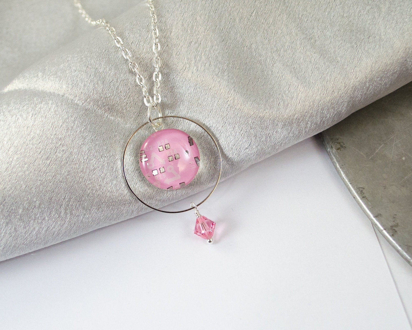 pink circuit board necklace with ring and bead decoration