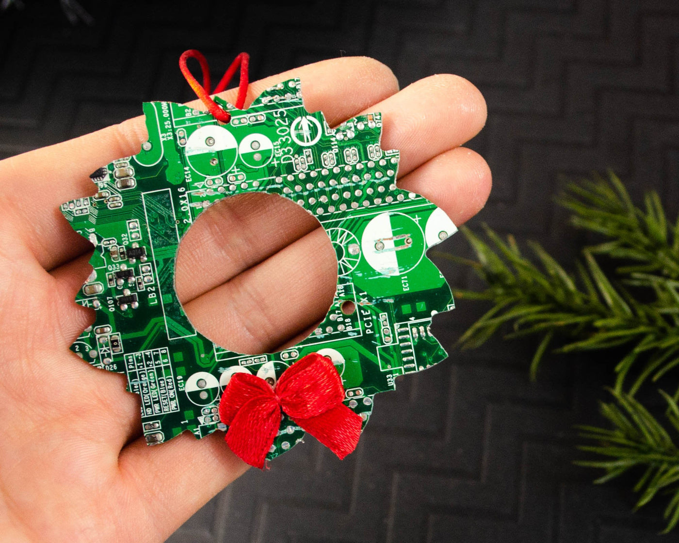 handmade green circuit board wreath ornament with red satin bow