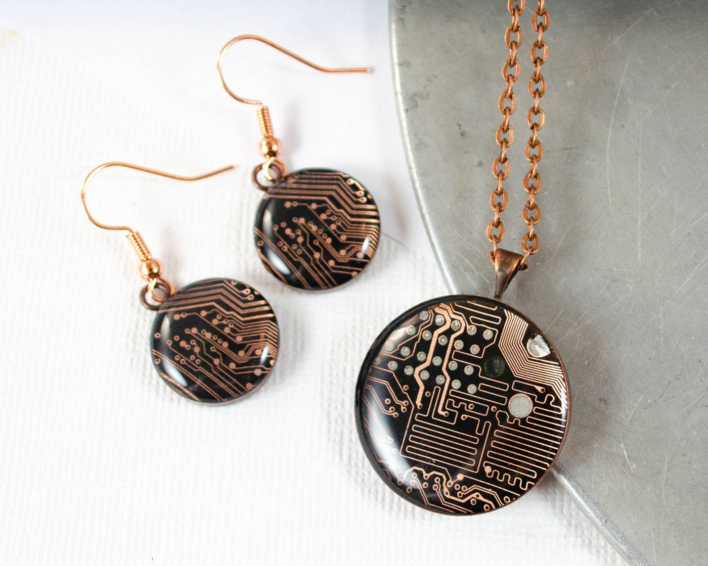 handmade necklace and earrings set made from recycled circuit board and set in copper