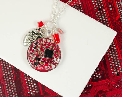 handmade circuit board cluster necklace with diode, anatomical heart charm, resistor, and crystal bead