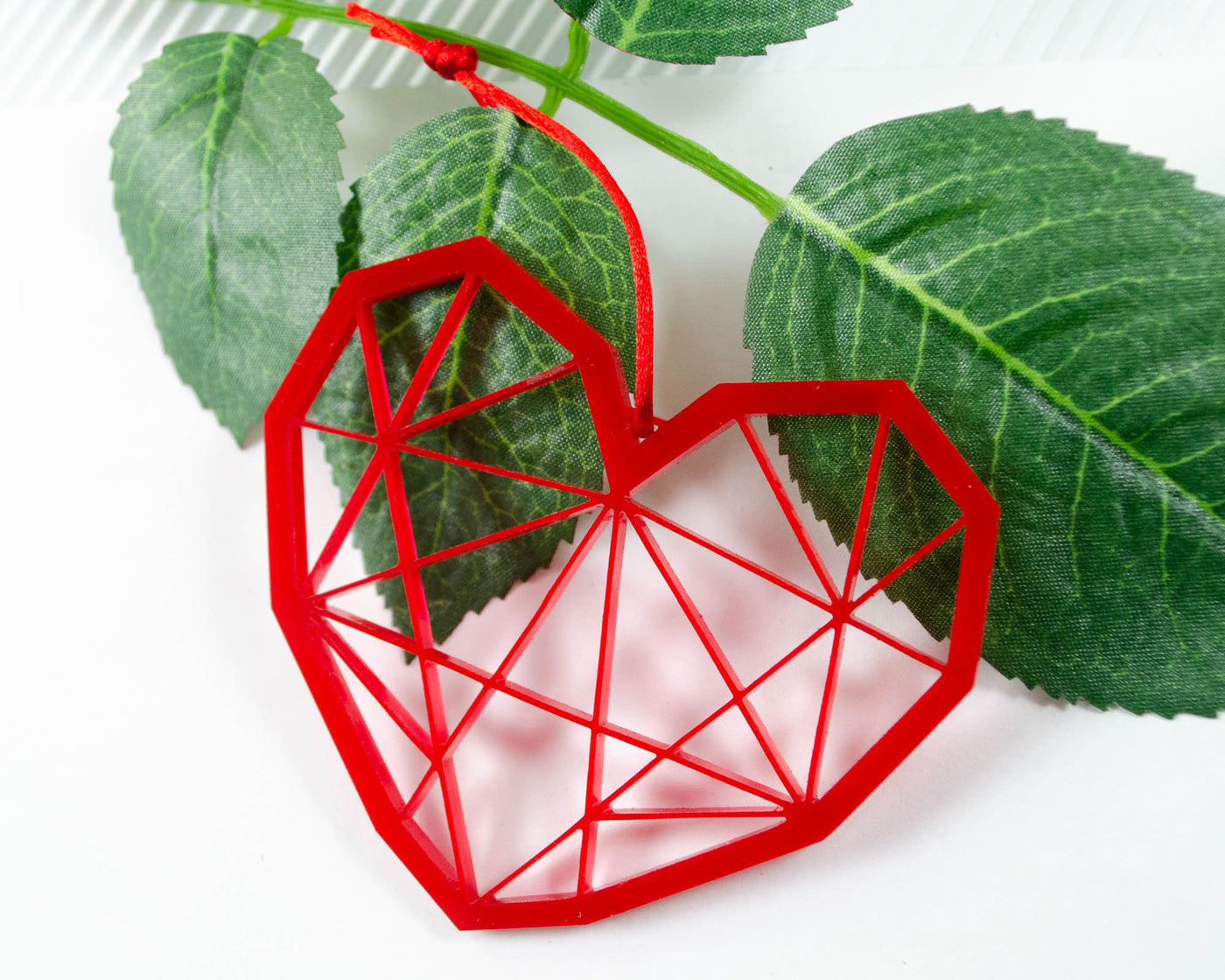 red laser cut ornament in shape of geometric heart