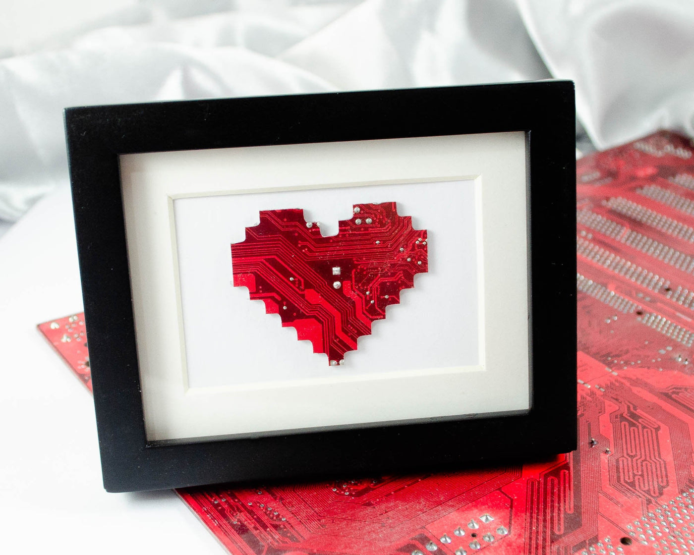 handmade art piece of a pixelated heart made from recycled circuit board