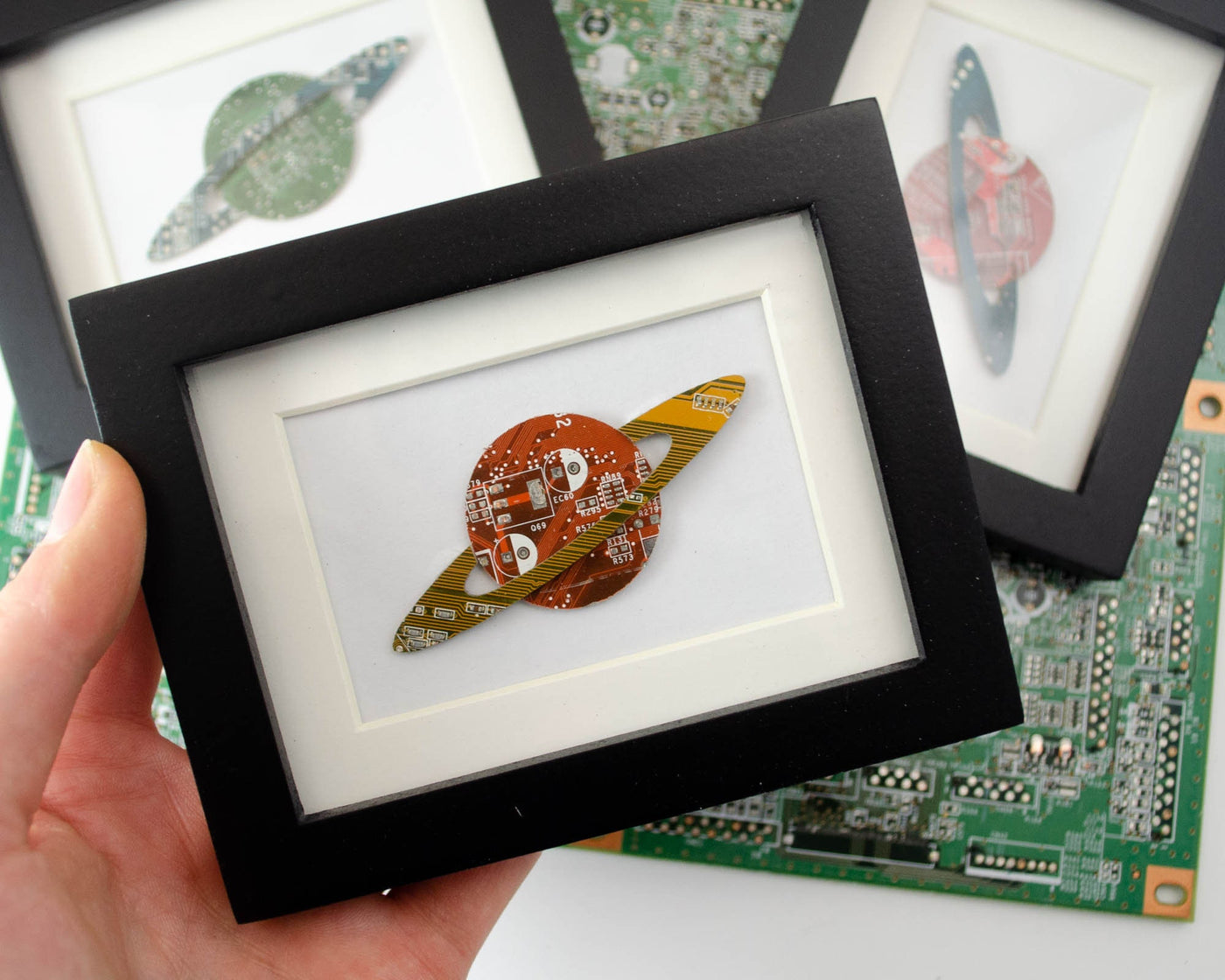 handmade framed art gift made from recycled circuit boards is made into the shape of saturn and you can select the color for the planet and ring