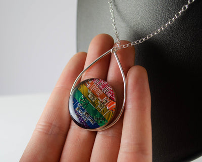 handmade metalsmithed necklace made from strips of recycled circuit board that were arranged into a rainbow. 