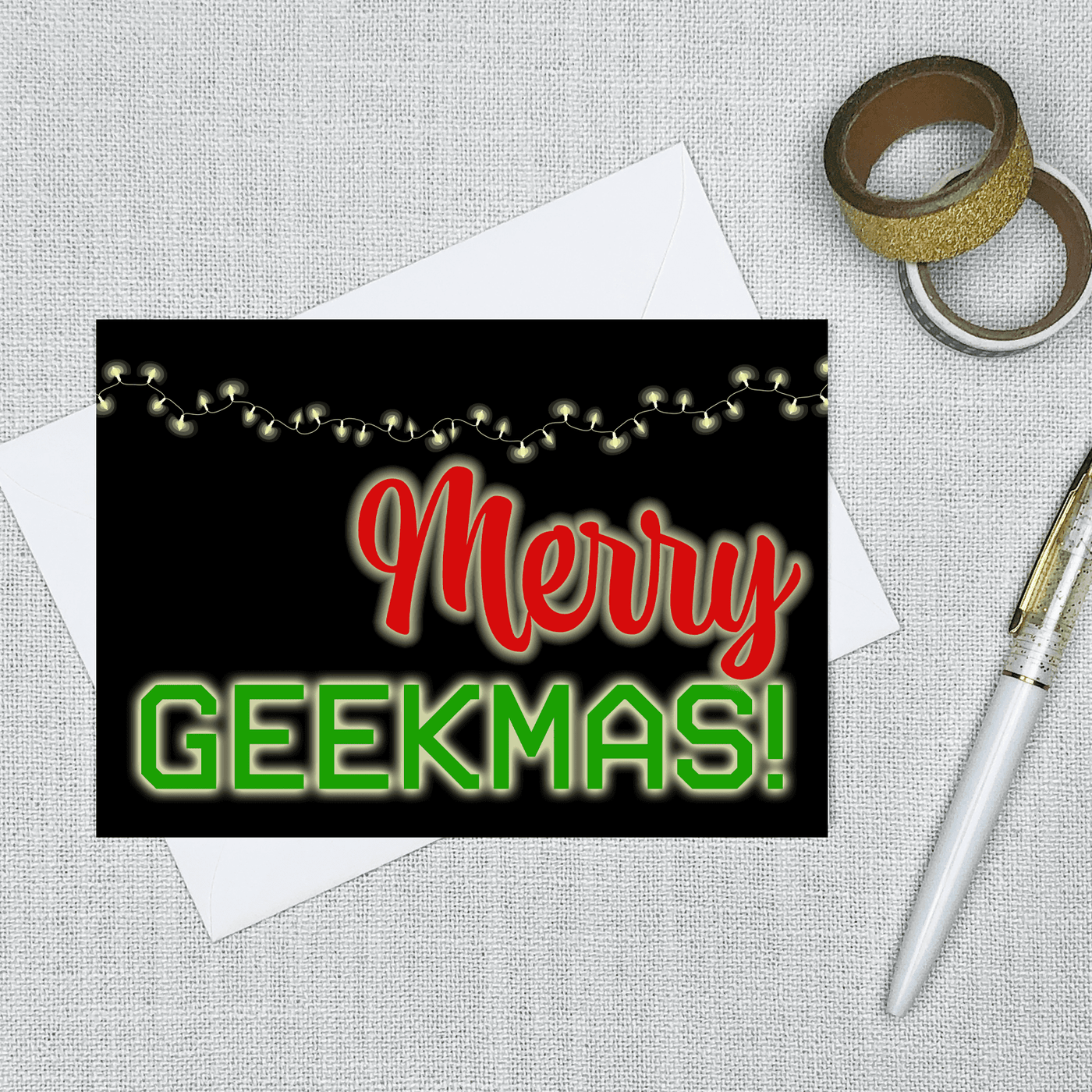 blank inside greeting card with text that says merry geekmas and a string of lights
