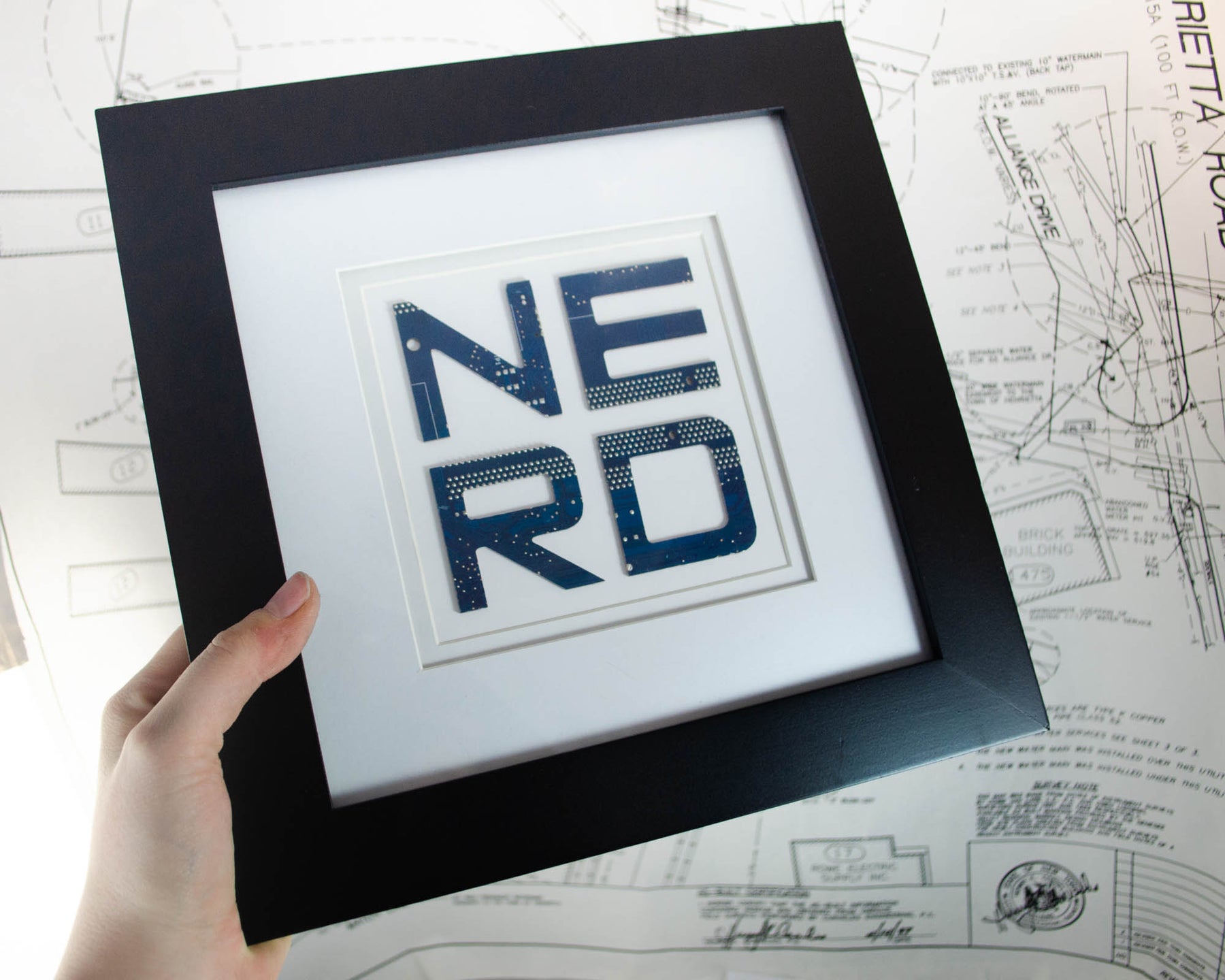 recycled circuit board art spelling out NERD